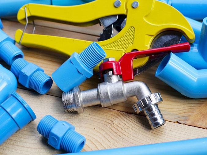 Blue PVC fittings with a PVC cutting tool