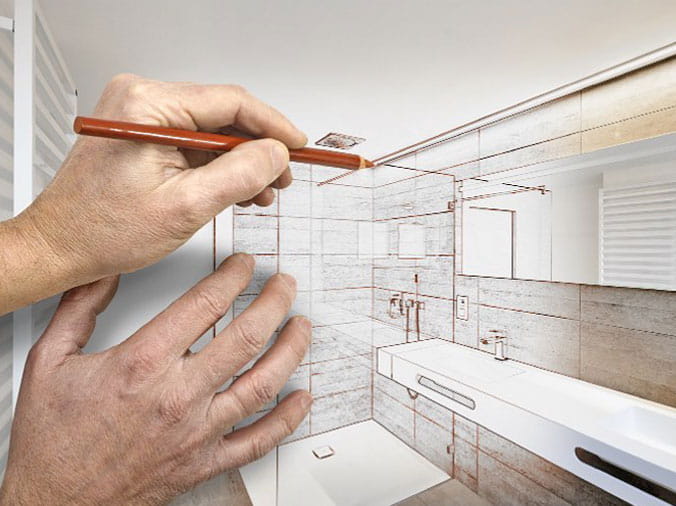 Hands drawing on a renovation planning drawing