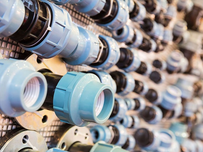 PVC unions on a pegboard in a plumbign supplies store
