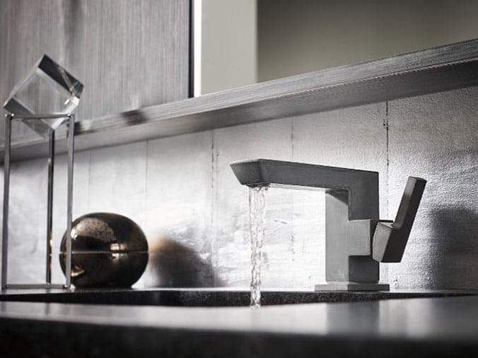 Bathroom sink with modern brushed steel faucets