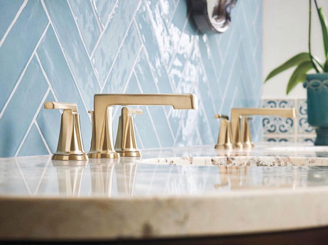Bathroom sink with gold colored faucet