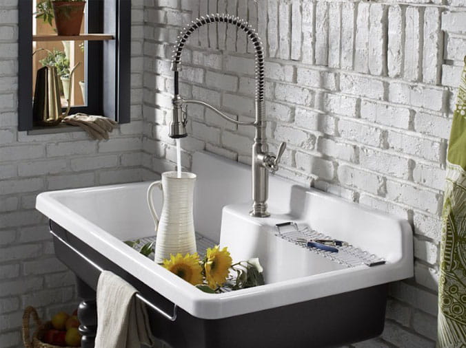 Goosenect kitchen faucet filling up a white vase