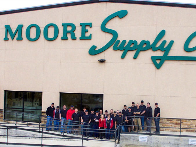 Moore Supply Denton building exterior with staff standing in front